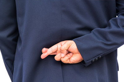 can-i-trust-the-insurance-company Insurance agent with fingers crossed behind back discussing a personal injury claim